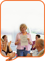 a lady talking to a group of people