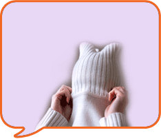 a lady pulling on a jumper